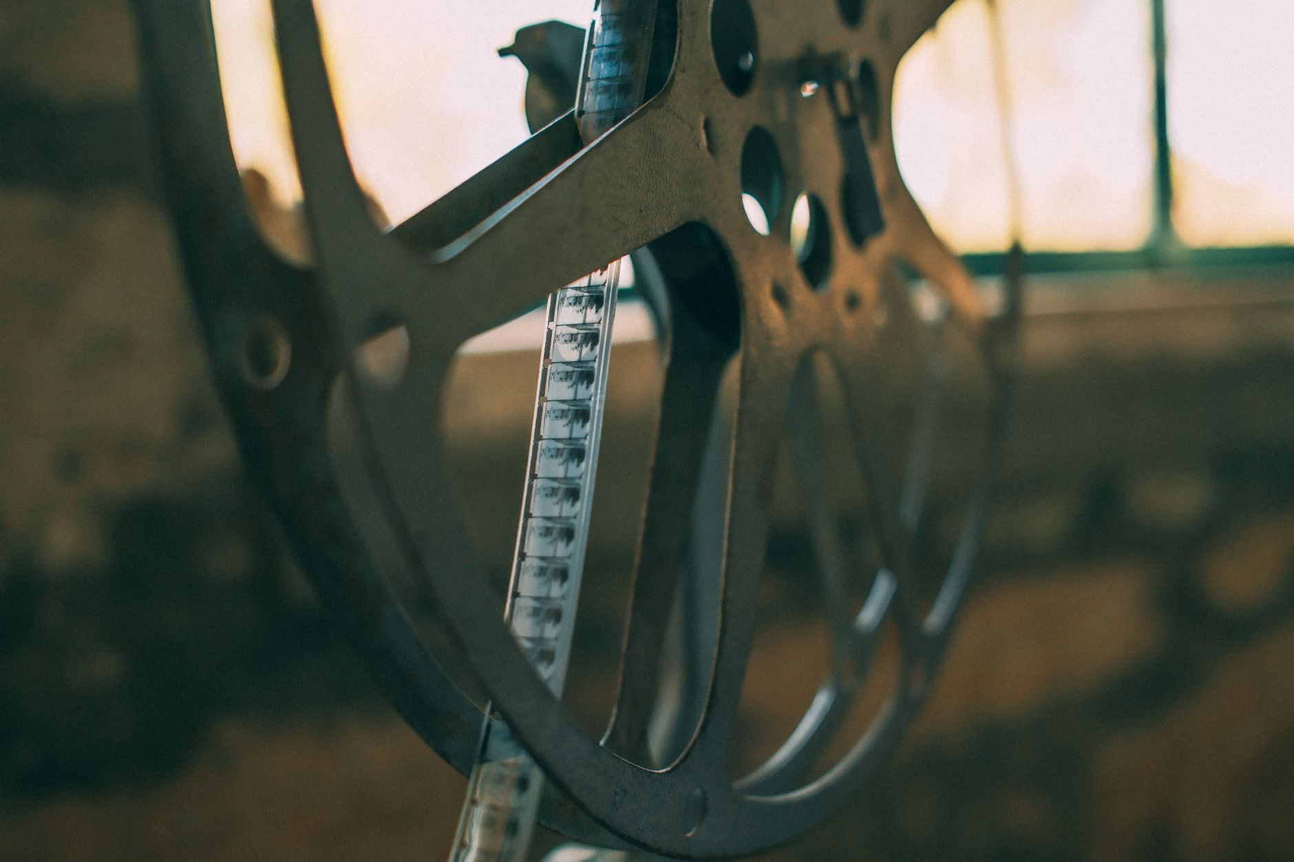 Vintage film reel on a cinema projector in a dark room